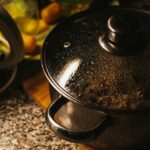 stainless steel cooking pot on brown wooden chopping board