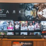 black flat screen tv turned on displaying man in black suit